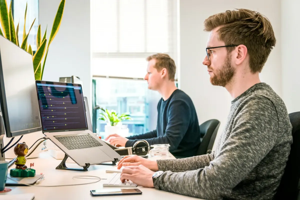 Tech Team 4U engineers pair-programming on an AI platform build