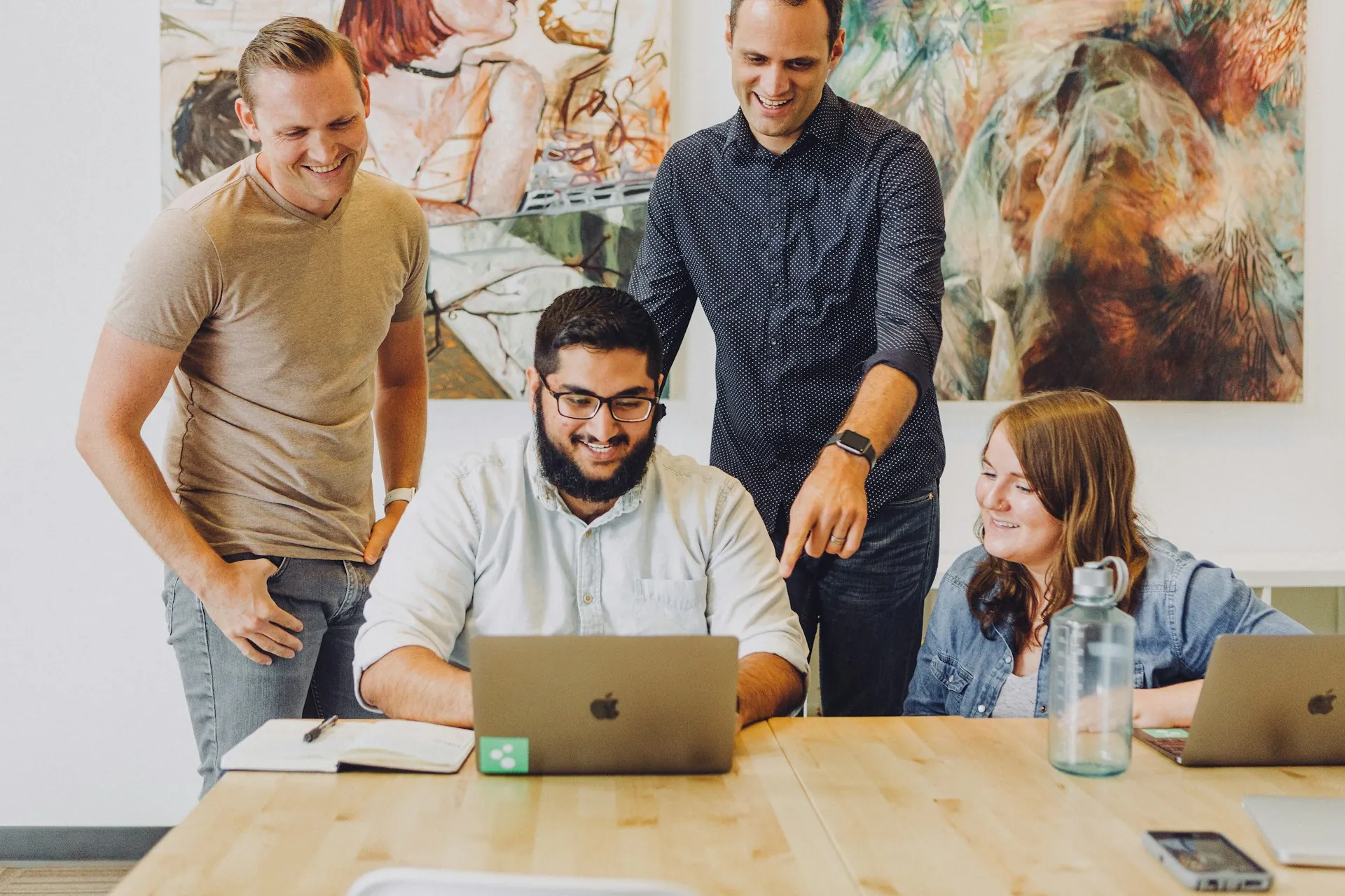 Mobile app development team reviewing UI design: Custom SaaS Development: Architecture Decisions That Compound