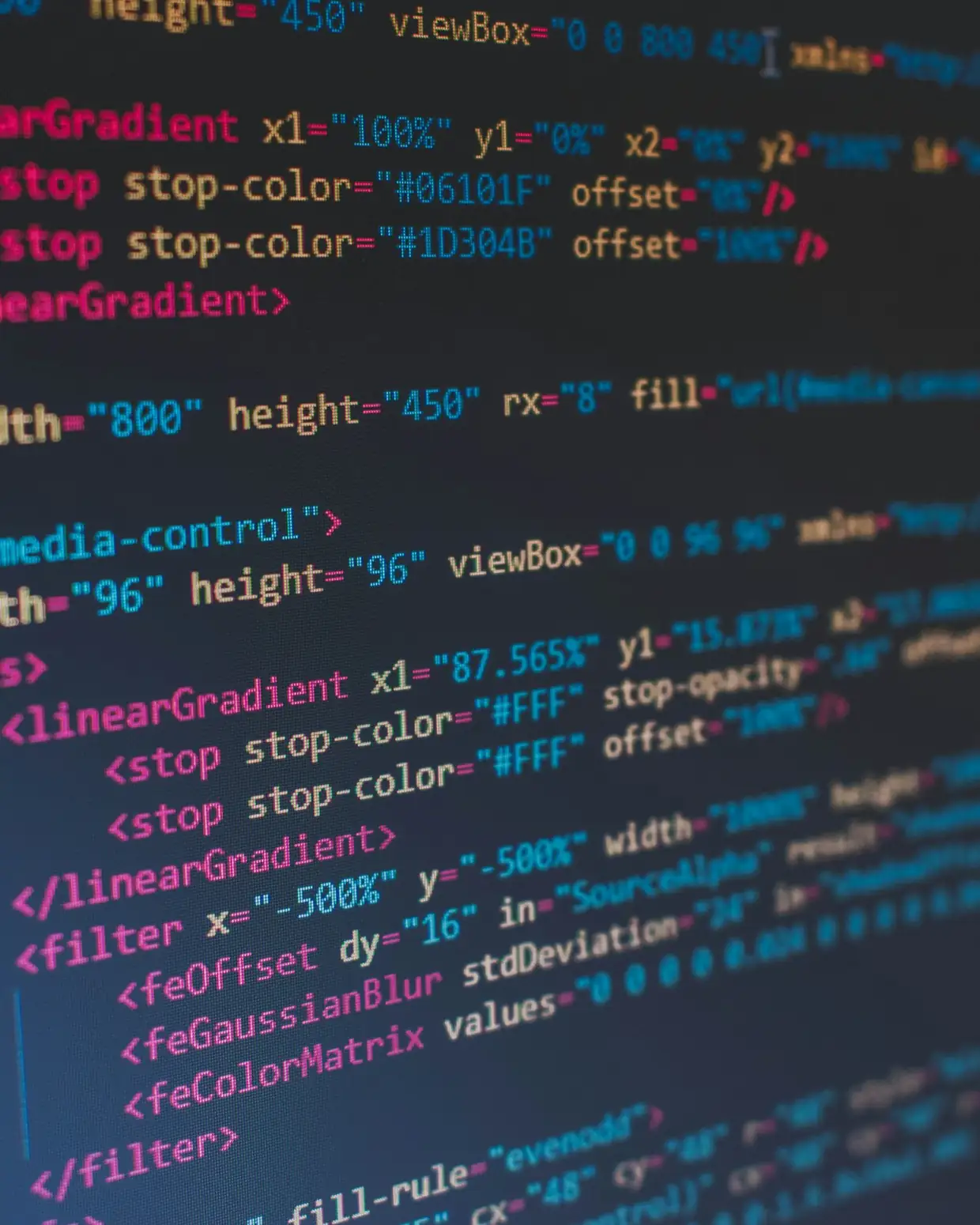 Programmer writing code on a large monitor